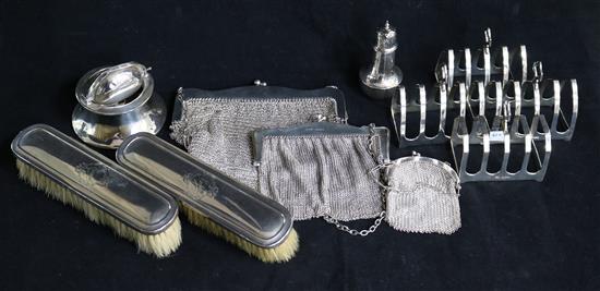 A set of three 1930s silver toastracks by Viners Ltd, one other silver toastrack and seven other items including mesh bags.